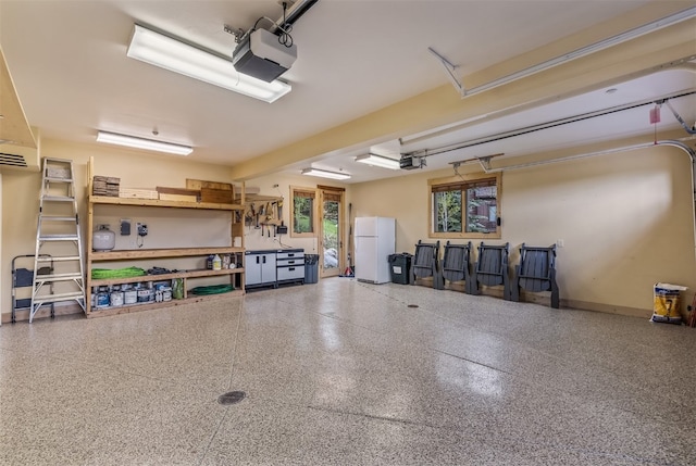 2655 Hunters Knob Rd, Silverthorne, CO 80498 - garage featuring freestanding refrigerator, a garage door opener, and baseboards