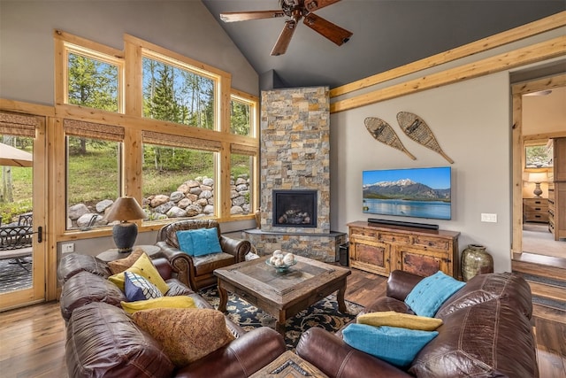 2655 Hunters Knob Rd, Silverthorne, CO 80498 - living area with a ceiling fan, healthy amount of natural light, wood-type flooring, high vaulted ceiling, and a stone fireplace