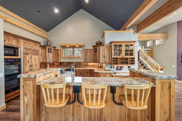 2655 Hunters Knob Rd, Silverthorne, CO 80498 - kitchen featuring black microwave, dark wood-type flooring, high vaulted ceiling, a spacious island, and brown cabinets