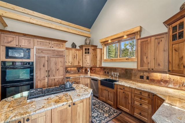 2655 Hunters Knob Rd, Silverthorne, CO 80498 - kitchen with a sink, black appliances, light stone countertops, a kitchen island, and glass insert cabinets