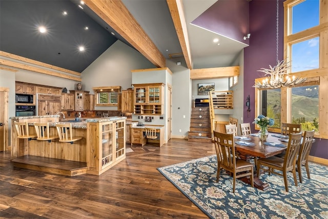 2655 Hunters Knob Rd, Silverthorne, CO 80498 - dining space featuring high vaulted ceiling, baseboards, beam ceiling, dark wood-type flooring, and a chandelier
