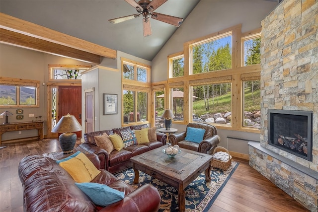 2655 Hunters Knob Rd, Silverthorne, CO 80498 - living area with high vaulted ceiling, wood-type flooring, a ceiling fan, and a fireplace