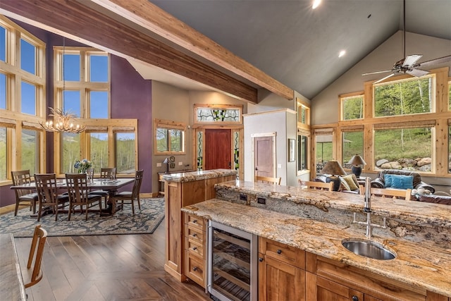 2655 Hunters Knob Rd, Silverthorne, CO 80498 - kitchen with wine cooler, high vaulted ceiling, a sink, open floor plan, and baseboards