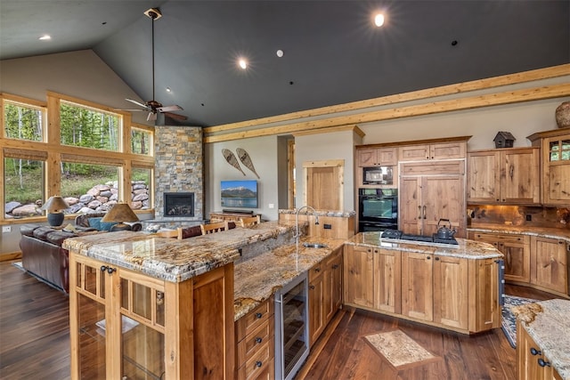2655 Hunters Knob Rd, Silverthorne, CO 80498 - kitchen with beverage cooler, a sink, high vaulted ceiling, open floor plan, and black appliances