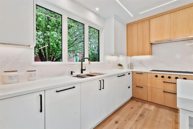 24 Maple St, Steamboat Springs, CO 80487 - kitchen featuring a sink, decorative backsplash, light wood-style floors, light countertops, and recessed lighting