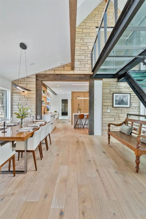 24 Maple St, Steamboat Springs, CO 80487 - dining space featuring a towering ceiling, hardwood / wood-style flooring, and wood walls