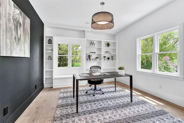 24 Maple St, Steamboat Springs, CO 80487 - home office with plenty of natural light, wood finished floors, and baseboards