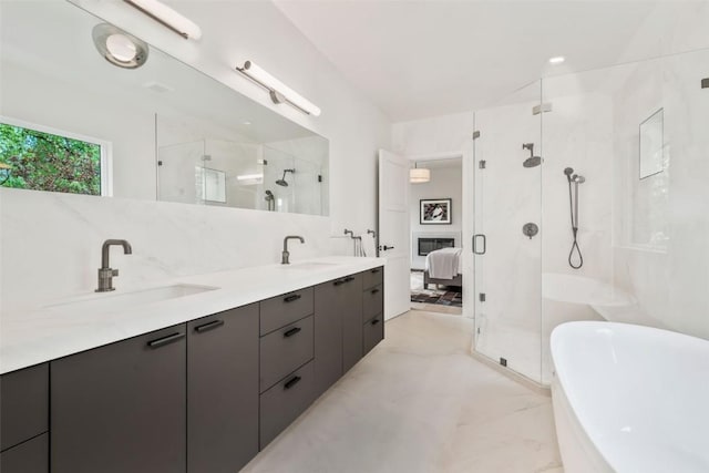 24 Maple St, Steamboat Springs, CO 80487 - ensuite bathroom with a shower stall, a freestanding tub, marble look tiles, and double vanity
