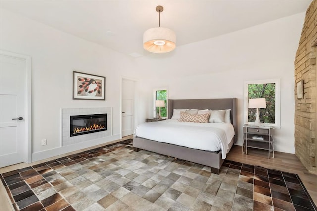 24 Maple St, Steamboat Springs, CO 80487 - bedroom with a glass covered fireplace, multiple windows, and stone finish floors
