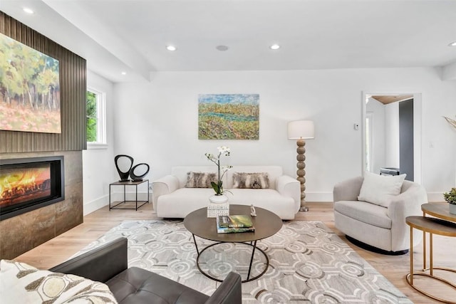 24 Maple St, Steamboat Springs, CO 80487 - living room with a tiled fireplace, recessed lighting, wood finished floors, and baseboards