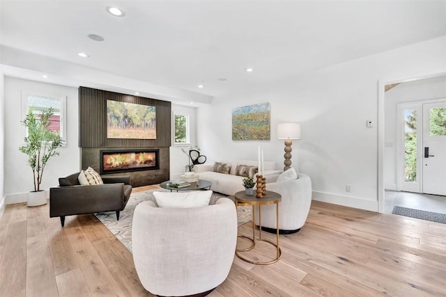 24 Maple St, Steamboat Springs, CO 80487 - living area featuring light wood-type flooring, recessed lighting, baseboards, and a glass covered fireplace