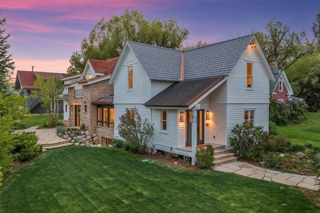 24 Maple St, Steamboat Springs, CO 80487 - view of front of house with a lawn and a chimney