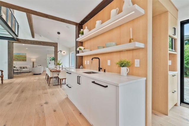 24 Maple St, Steamboat Springs, CO 80487 - kitchen featuring a sink, open shelves, modern cabinets, light countertops, and light wood-style flooring