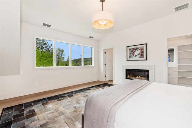 24 Maple St, Steamboat Springs, CO 80487 - bedroom with wood finished floors, baseboards, and a glass covered fireplace
