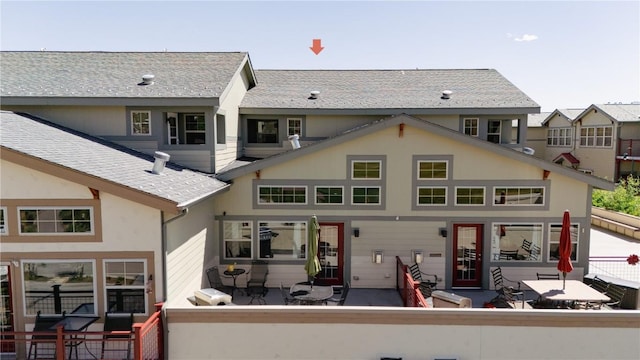 135 Main St Unit 202, Dillon, CO 80435 - rear view of house featuring a patio and roof with shingles