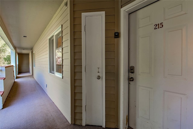 view of exterior entry featuring covered porch