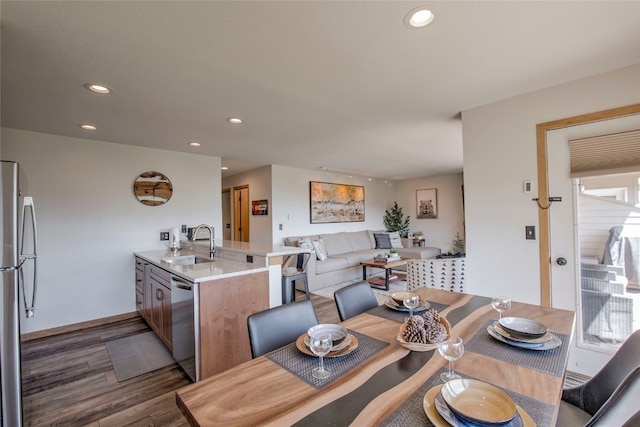 dining room with baseboards, dark wood-style floors, and recessed lighting