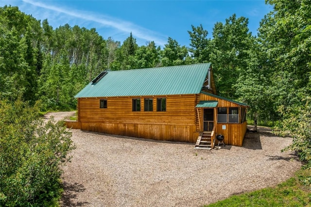 389 Routt Forest Loop, Craig, CO 81625 - view of front of property with log exterior, a metal roof, and entry steps