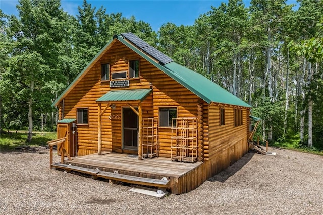389 Routt Forest Loop, Craig, CO 81625 - view of front facade featuring log exterior, a wooden deck, and a metal roof