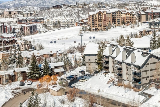 snowy aerial view with a mountain view