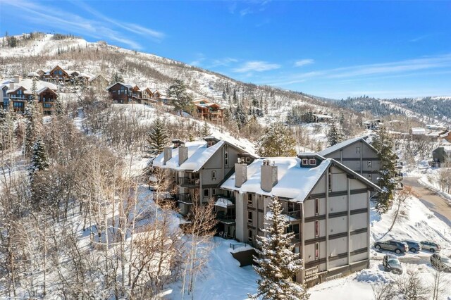 snowy aerial view with a mountain view