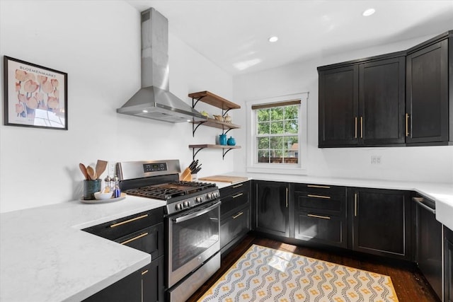 225 N Poplar St, Hayden, CO 81639 - kitchen with stainless steel gas stove, exhaust hood, dark cabinetry, dark wood-style flooring, and recessed lighting