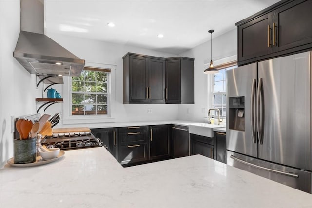 225 N Poplar St, Hayden, CO 81639 - kitchen with stainless steel fridge, wall chimney exhaust hood, a sink, decorative light fixtures, and recessed lighting