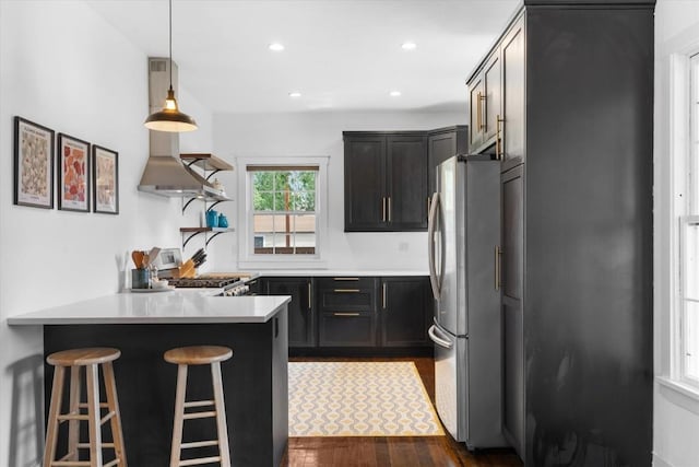 225 N Poplar St, Hayden, CO 81639 - kitchen featuring freestanding refrigerator, a peninsula, open shelves, range, and dark wood finished floors