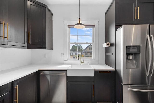 225 N Poplar St, Hayden, CO 81639 - kitchen with stainless steel appliances, a sink, decorative light fixtures, and light countertops