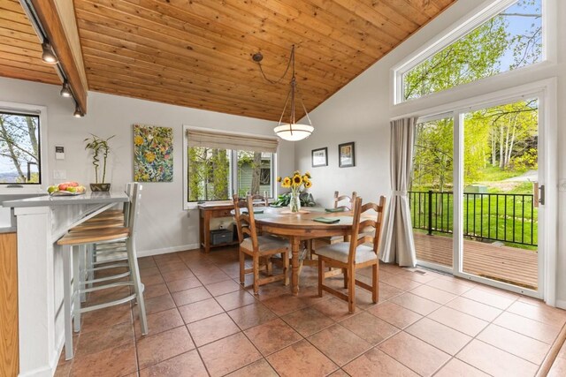 1763 Brome Dr, Steamboat Springs, CO 80487 - dining area featuring wood ceiling, light tile patterned floors, baseboards, beam ceiling, and high vaulted ceiling