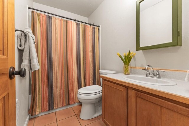 1763 Brome Dr, Steamboat Springs, CO 80487 - bathroom with toilet, tile patterned floors, vanity, and a shower with shower curtain