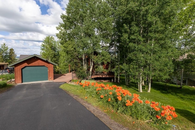 1763 Brome Dr, Steamboat Springs, CO 80487 - view of front of house with a front lawn, a detached garage, and an outdoor structure