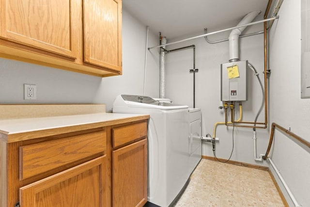 1763 Brome Dr, Steamboat Springs, CO 80487 - laundry room with cabinet space, washer and clothes dryer, light floors, water heater, and baseboards