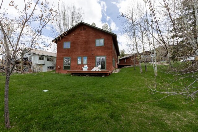 1763 Brome Dr, Steamboat Springs, CO 80487 - back of property featuring a wooden deck and a lawn
