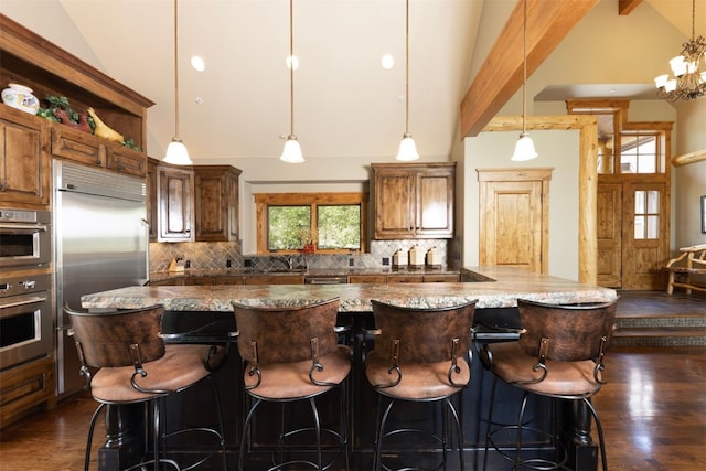 460 Two Cabins Dr, Silverthorne, CO 80498 - kitchen featuring dark wood-style flooring, decorative backsplash, a large island, high vaulted ceiling, and beamed ceiling