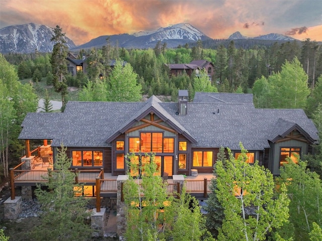 460 Two Cabins Dr, Silverthorne, CO 80498 - back of property at dusk with a deck with mountain view and roof with shingles