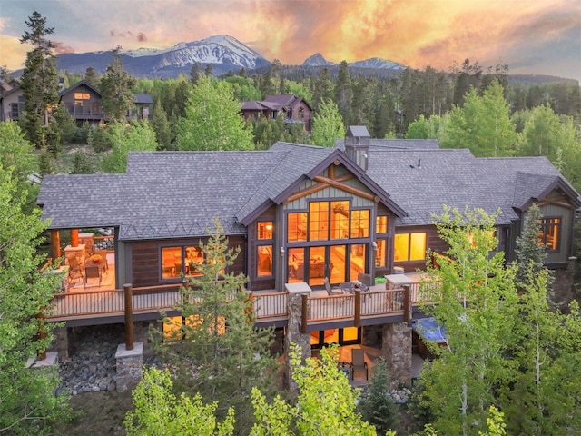 460 Two Cabins Dr, Silverthorne, CO 80498 - back of house featuring roof with shingles, a deck with mountain view, and a chimney
