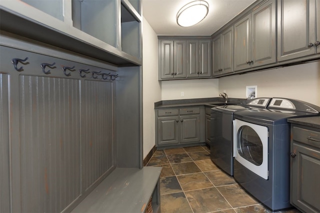 460 Two Cabins Dr, Silverthorne, CO 80498 - laundry room featuring cabinet space, washer and clothes dryer, and stone finish flooring