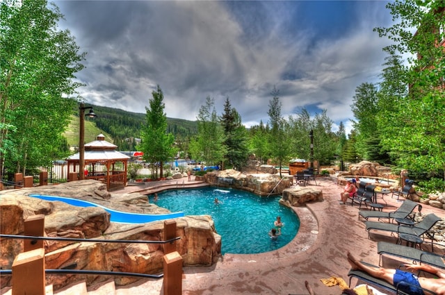 community pool featuring a gazebo and a patio area