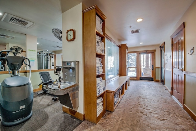 corridor featuring baseboards, visible vents, and carpet