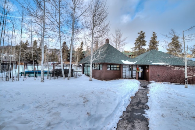 53 Hunki Dori Ct Unit 8863, Keystone, CO 80435 - view of front of home with fence, a chimney, and roof with shingles