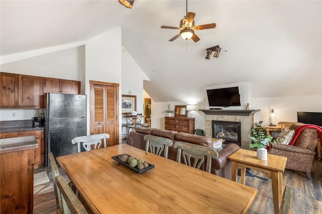 505 S Main St Unit 2207, Breckenridge, CO 80424 - dining space with lofted ceiling, ceiling fan, wood finished floors, and a tiled fireplace