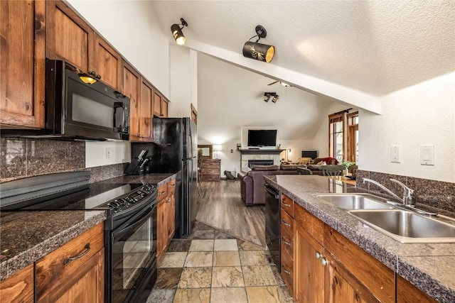 505 S Main St Unit 2207, Breckenridge, CO 80424 - kitchen with black appliances, vaulted ceiling, brown cabinetry, a sink, and open floor plan