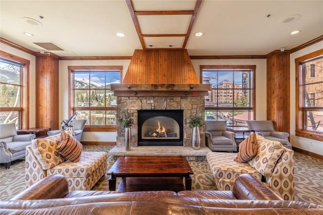 505 S Main St Unit 2207, Breckenridge, CO 80424 - living area featuring baseboards, ornamental molding, a stone fireplace, plenty of natural light, and carpet flooring