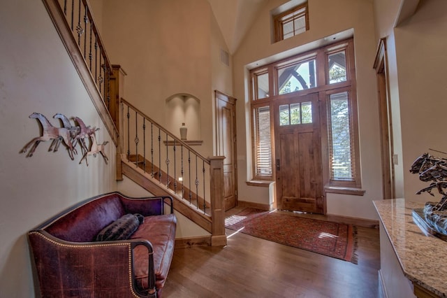 862 Penstemon Rd, Keystone, CO 80435 - entryway with stairway, wood finished floors, a towering ceiling, baseboards, and visible vents
