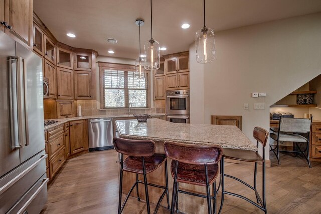 862 Penstemon Rd, Keystone, CO 80435 - kitchen with recessed lighting, light wood-style floors, light stone countertops, a center island, and appliances with stainless steel finishes