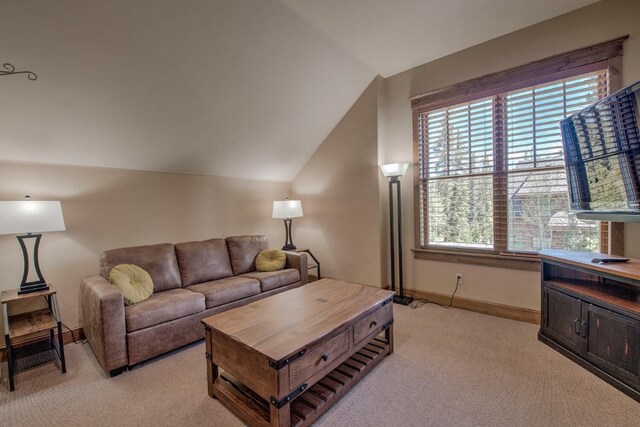 862 Penstemon Rd, Keystone, CO 80435 - living area featuring baseboards, vaulted ceiling, and light colored carpet