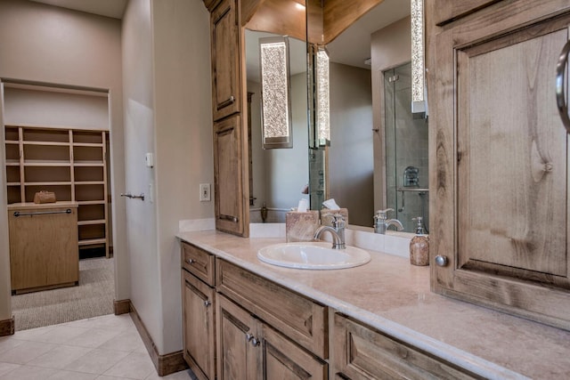 862 Penstemon Rd, Keystone, CO 80435 - full bathroom with a shower stall, tile patterned flooring, vanity, a walk in closet, and baseboards