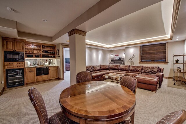 862 Penstemon Rd, Keystone, CO 80435 - dining room featuring a raised ceiling, beverage cooler, baseboards, and light carpet