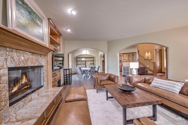 862 Penstemon Rd, Keystone, CO 80435 - living room featuring a premium fireplace, wood finished floors, arched walkways, and stairs